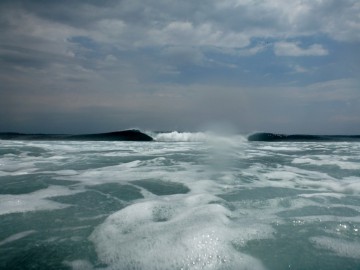 In one area of the island big waves break on the reef in the distance