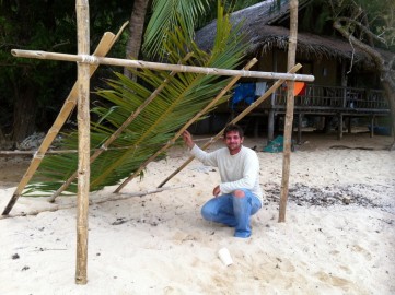 Terence building the small shelter next to the cottage