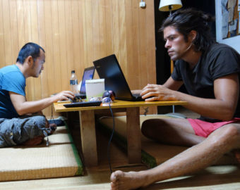 Alvaro Cerezo and Tamiki Kato from Docastaway working in front of laptops